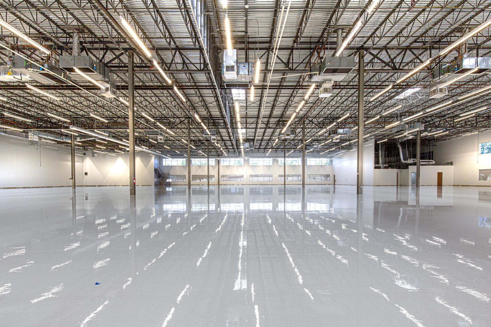Bright high-gloss epoxy floor running the length of a Tampa warehouse